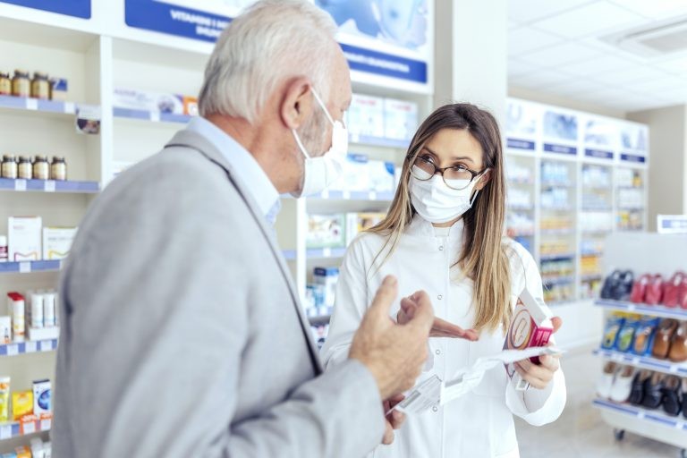 Farmacêutica orienta idoso sobre bula de remédio - (Foto: Depositphotos)
